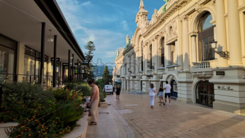 Video - Monte Carlo, Monaco - October 4, 2024: Luxury stores on a street in the city with people walking around