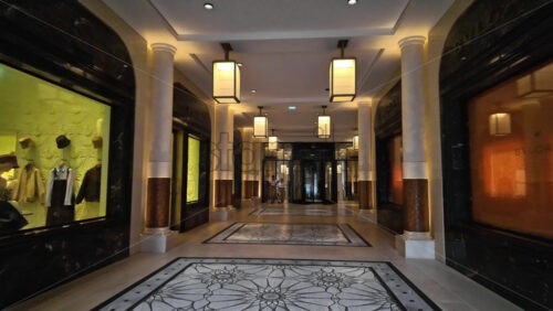 Video - Monte Carlo, Monaco - October 4, 2024: Luxury stores on a street in the city with people walking around