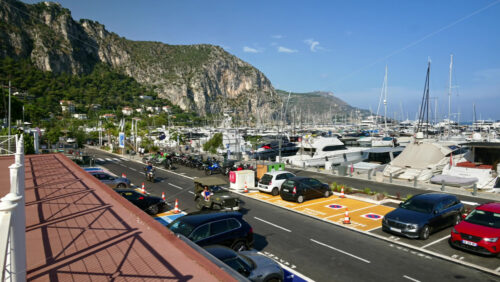 Video - Beaulieu-sur-Mer, France - July 5, 2024: Cars moving on the streets of the city near the port