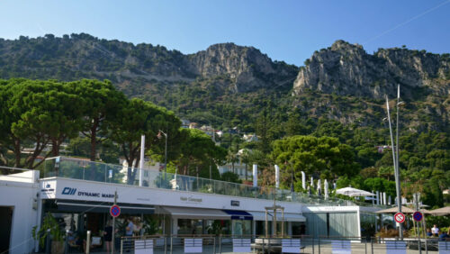 Video - Beaulieu-sur-Mer, France - July 5, 2024: Cars moving on the streets of the city near the port