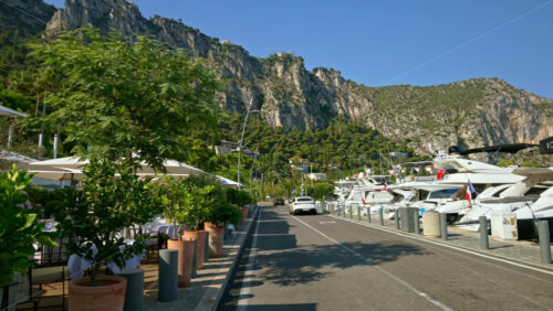 Video - Beaulieu-sur-Mer, France - July 5, 2024: Cars moving on the streets of the city near the port