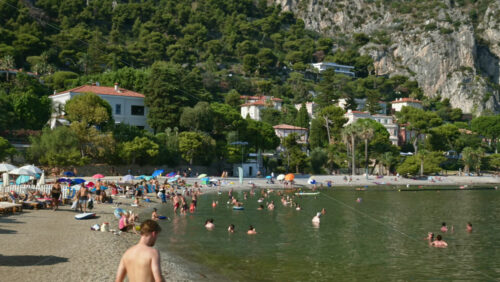 Video - Beaulieu-sur-Mer, France - July 5, 2024: People swimming and relaxing at the Petite Afrique Beach