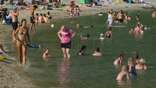Video - Beaulieu-sur-Mer, France - July 5, 2024: People swimming and relaxing at the Petite Afrique Beach