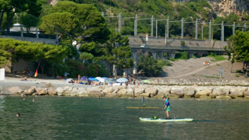 Video - Beaulieu-sur-Mer, France - July 5, 2024: People swimming and relaxing at the Petite Afrique Beach