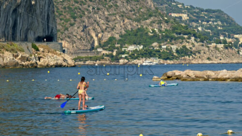 Video - Beaulieu-sur-Mer, France - July 5, 2024: People swimming and relaxing at the Petite Afrique Beach