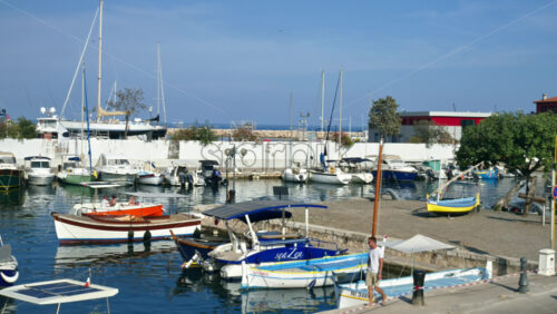 Video - Beaulieu-sur-Mer, France - June 28, 2024: View of white boats docked in the Beaulieu-sur-Mer harbour