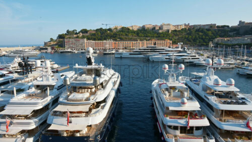 Video - View of white boats docked in the Monaco Marina with the skyline of the city on the background