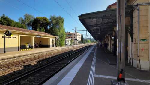 Video - Beaulieu-sur-Mer, France - July 5, 2024: People waiting for the trains at the Gare de Beaulieu-sur-Mer in daylight