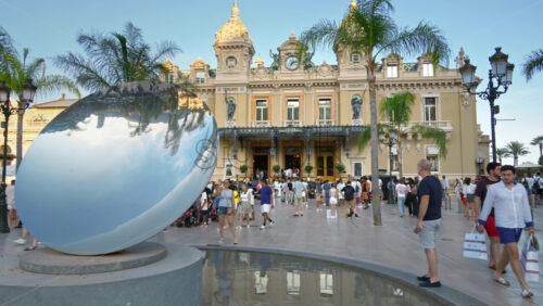 Video - Monte Carlo, Monaco - October 4, 2024: Sky mirror sculpture in front of The Monte Carlo Casino with people walking around it