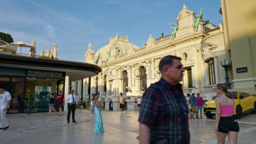 Video - Monaco City, Monaco - October 4, 2024: Luxury cars parked and people moving in front of a Tiffany and Co. store in the city