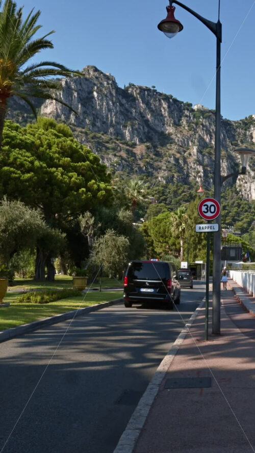 Video - Beaulieu-sur-Mer, France - July 5, 2024: Cars moving on the streets of the city in daylight. Vertical