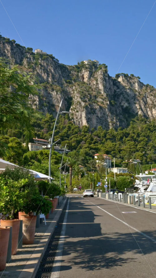 Video - Beaulieu-sur-Mer, France - July 5, 2024: Cars moving on the streets of the city near the port. Vertical