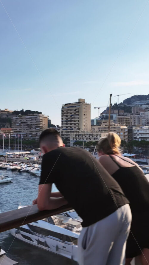Video - La Condamine, Monaco - September 8, 2024: View of white boats docked in the Monaco Marina with the skyline of the city on the background. Vertical
