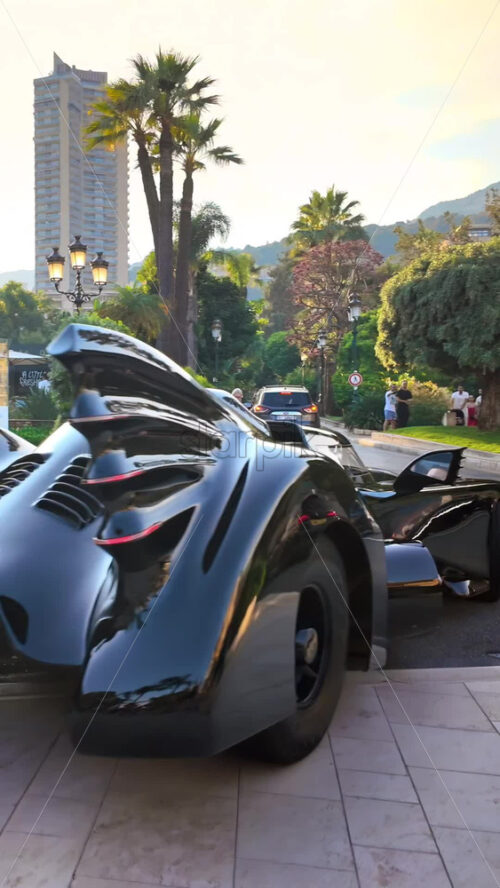 Video - Monte Carlo, Monaco - October 4, 2024: Luxury cars moving through the courtyard of the Monte Carlo Casino. Vertical