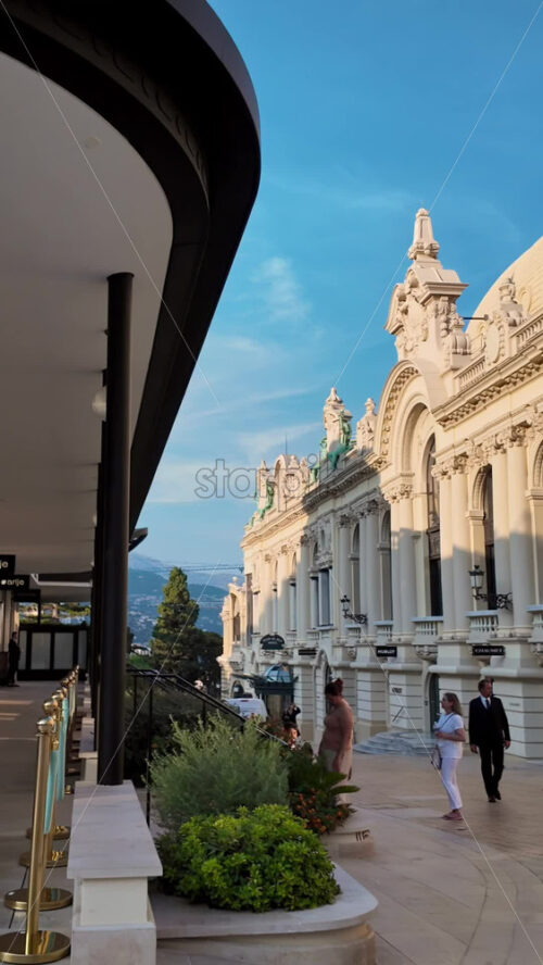 Video - Monte Carlo, Monaco - October 4, 2024: Luxury stores on a street in the city with people walking around. Vertical