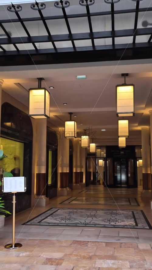 Video - Monte Carlo, Monaco - October 4, 2024: Luxury stores on a street in the city with people walking around. Vertical