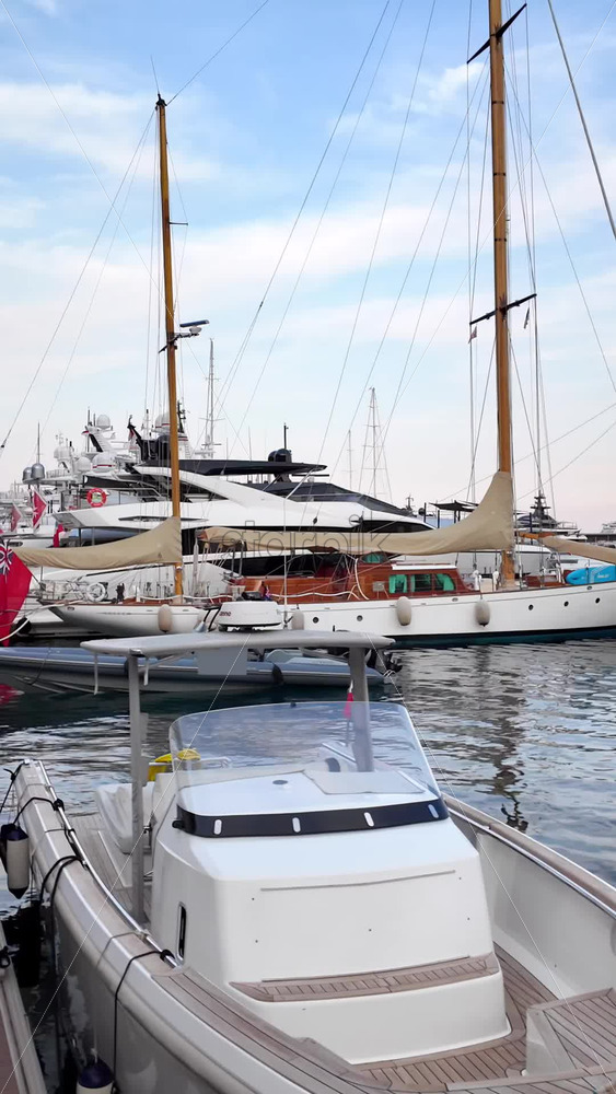Video - La Condamine, Monaco - September 8, 2024: People walking near white boats docked in the Monaco Marina. Vertical