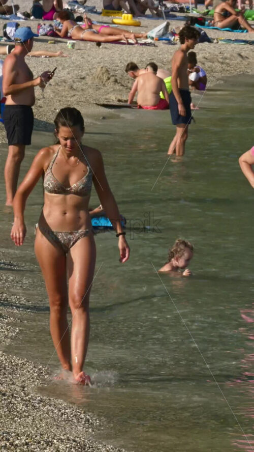 Video - Beaulieu-sur-Mer, France - July 5, 2024: People swimming and relaxing at the Petite Afrique Beach. Vertical