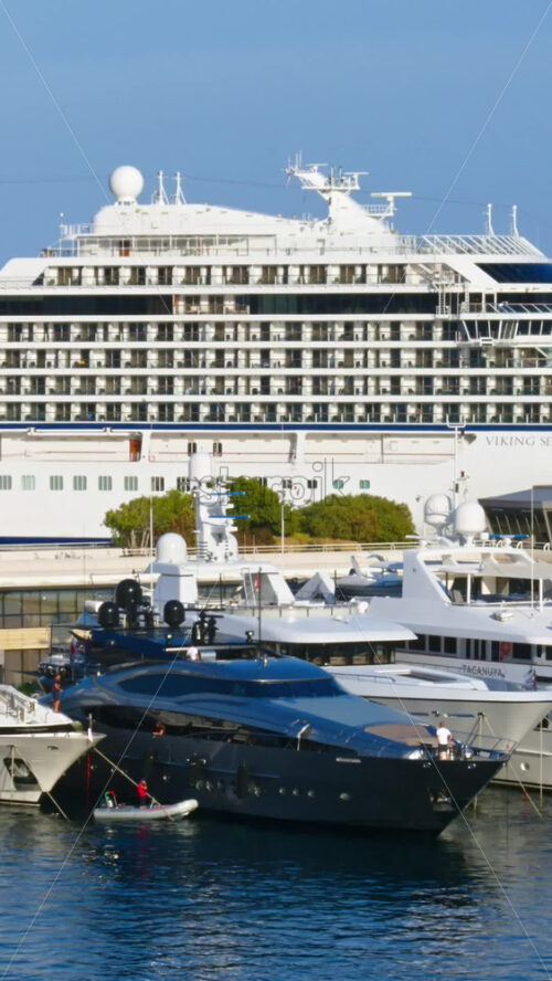 Video - La Condamine, Monaco - September 8, 2024: View of white yacht and multiple boats docked in the Monaco Marina. Vertical