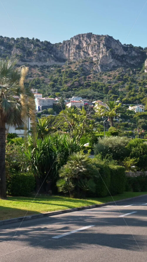 Video - Beaulieu-sur-Mer, France - July 5, 2024: Cars moving on the streets of the city in daylight. Vertical