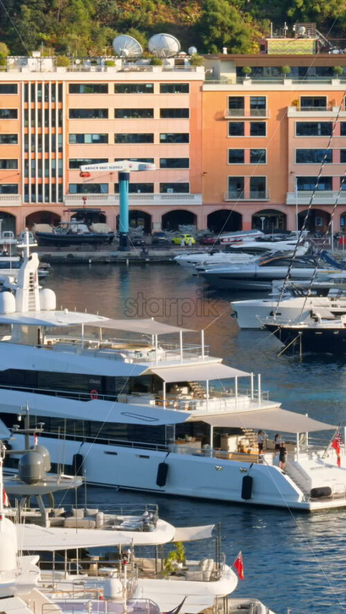 Video - La Condamine, Monaco - September 8, 2024: Boat moving on the sea through the Monaco Marina. Vertical