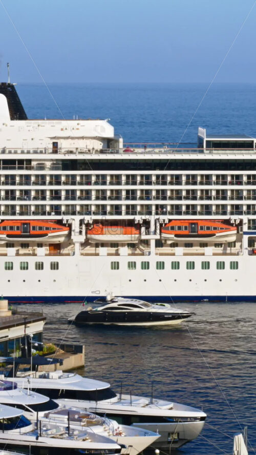Video - La Condamine, Monaco - September 8, 2024: View of white yacht and multiple boats docked in the Monaco Marina. Vertical