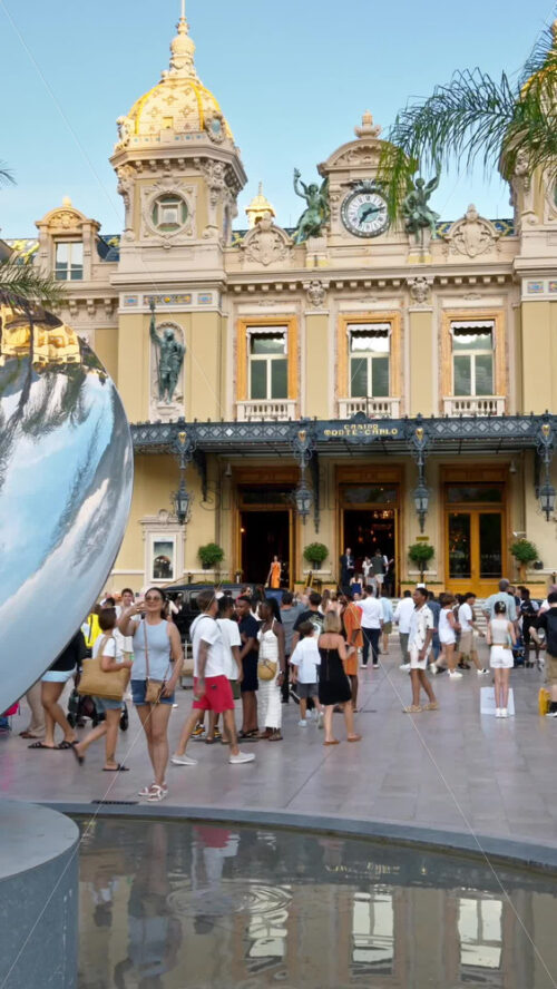 Video - Monte Carlo, Monaco - October 4, 2024: Sky mirror sculpture in front of The Monte Carlo Casino with people walking around it. Vertical