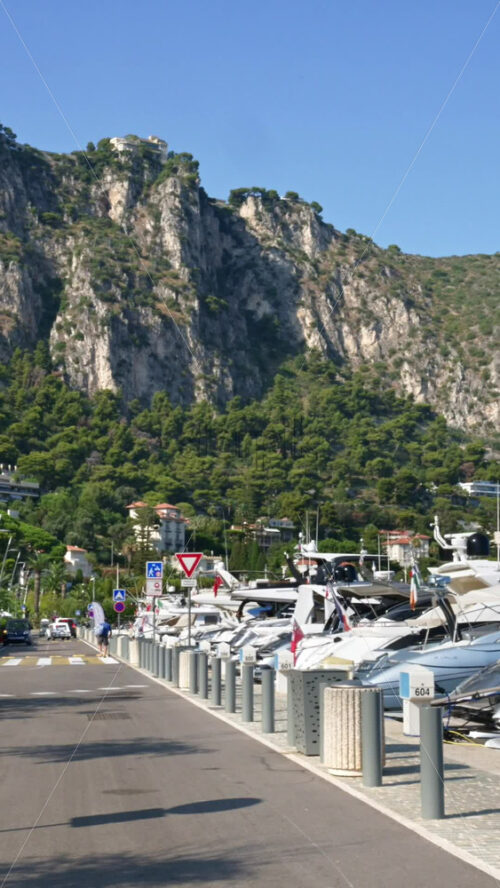 Video - Beaulieu-sur-Mer, France - July 5, 2024: Cars moving on the streets of the city near the port. Vertical