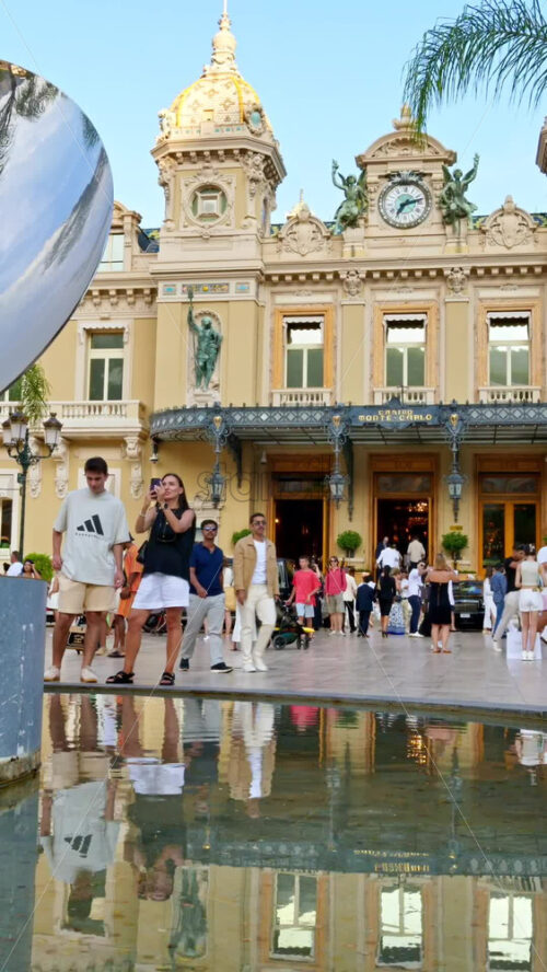 Video - Monte Carlo, Monaco - October 4, 2024: Sky mirror sculpture in front of The Monte Carlo Casino with people walking around it. Vertical