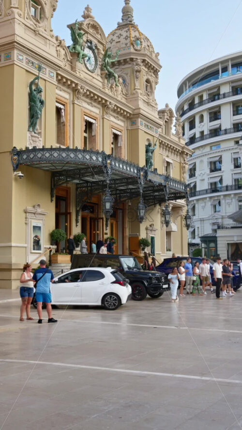 Video - Monte Carlo, Monaco - October 4, 2024: People walking through the courtyard of the Monte-Carlo Casino. Vertical