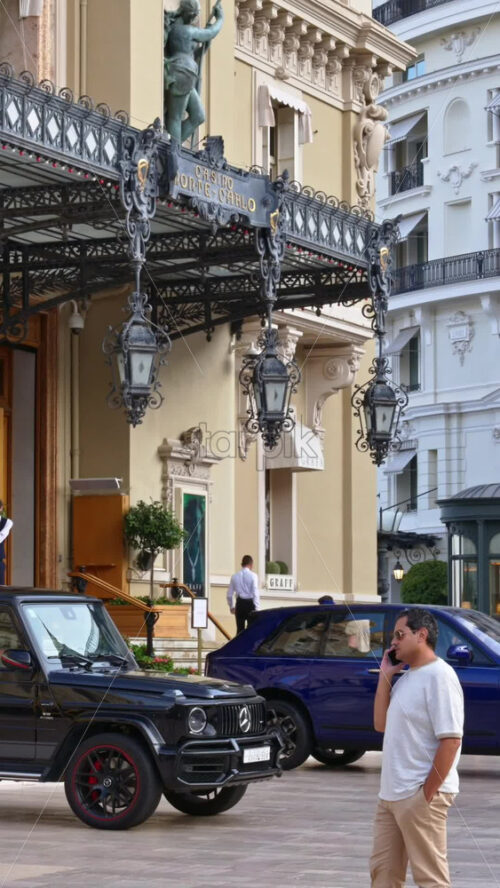 Video - Monte Carlo, Monaco - October 4, 2024: People walking through the courtyard of the Monte-Carlo Casino. Vertical