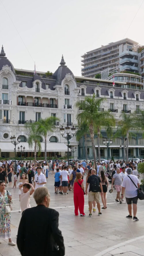 Video - Monte Carlo, Monaco - October 4, 2024: People walking through the courtyard of the Monte-Carlo Casino. Vertical