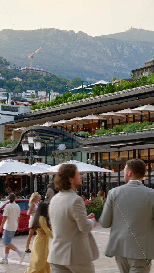 Video - Monaco City, Monaco - October 4, 2024: Luxury cars parked and people moving in front of a Tiffany and Co. store in the city. Vertical
