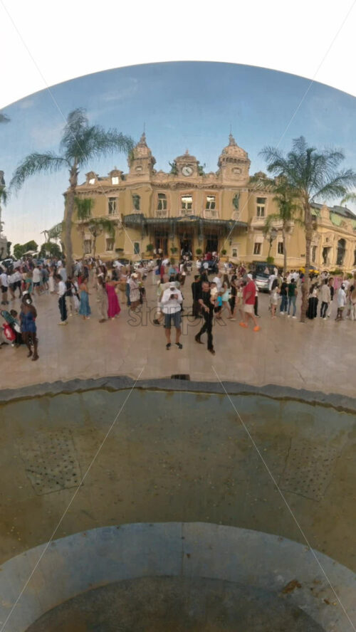 Video - Monte Carlo, Monaco - October 4, 2024: Sky mirror sculpture in front of The Monte Carlo Casino with people walking around it. Vertical