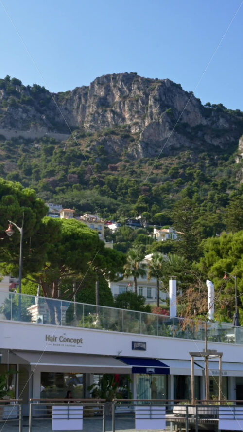 Video - Beaulieu-sur-Mer, France - July 5, 2024: Cars moving on the streets of the city near the port. Vertical