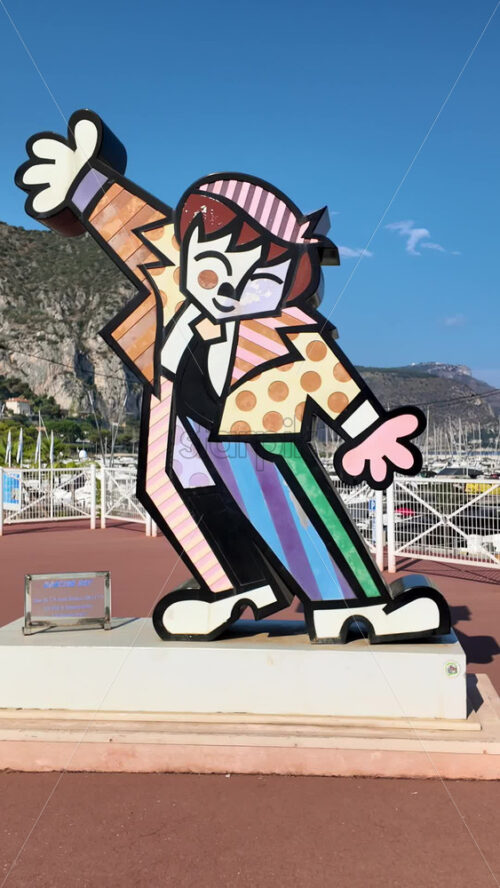 Video - Beaulieu-sur-Mer, France - July 5, 2024: Dancing Boy by Romero Britto figurine near a port. Vertical