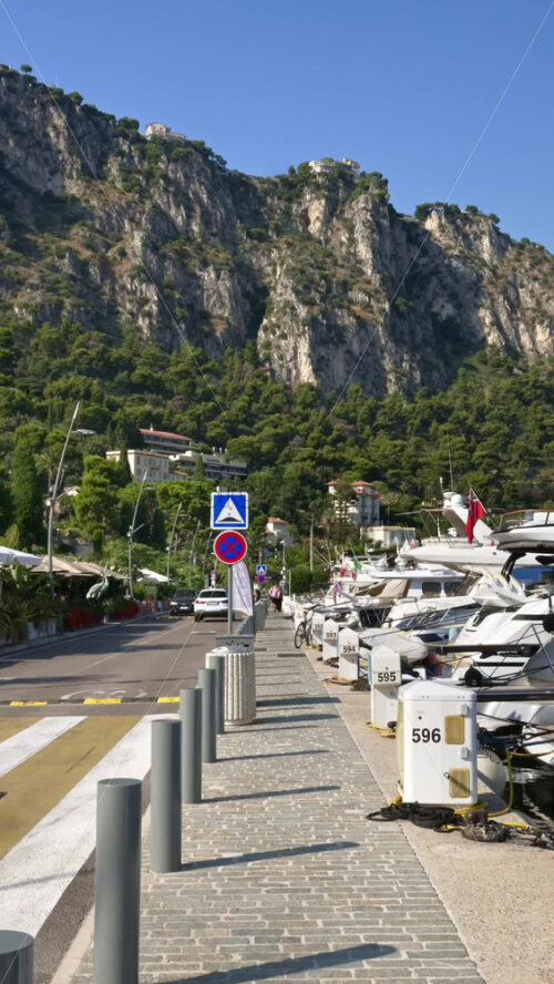 Video - Beaulieu-sur-Mer, France - July 5, 2024: Cars moving on the streets of the city near the port. Vertical