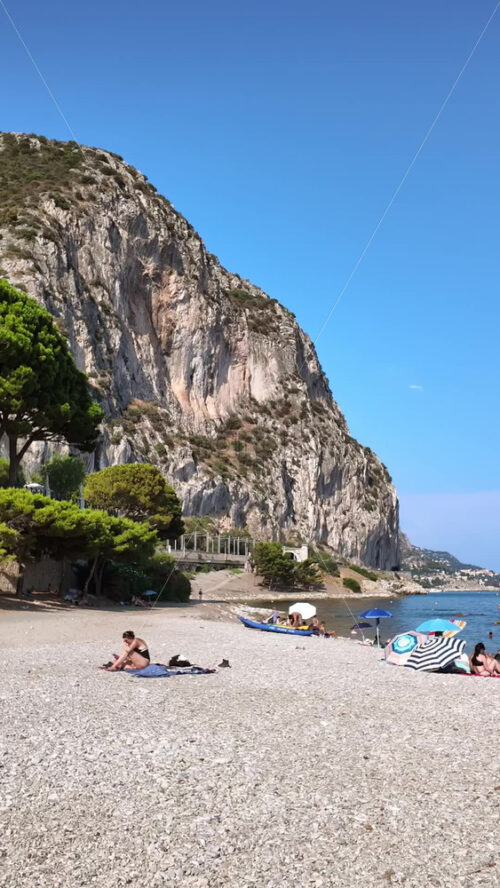 Video - Beaulieu-sur-Mer, France - July 5, 2024: People swimming and relaxing at the Petite Afrique Beach. Vertical