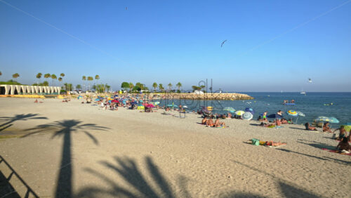 Video - Menton, France - September 4, 2024: People swimming and relaxing on the beach