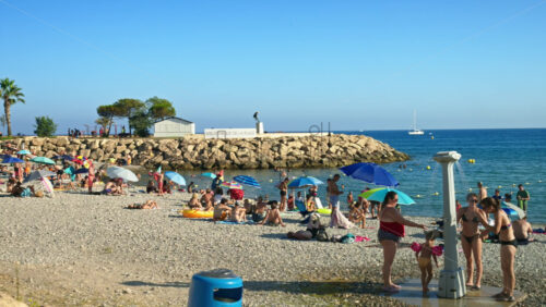 Video - Menton, France - September 4, 2024: People swimming and relaxing on the beach