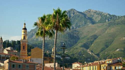 Video - Menton, France - September 4, 2024: Distant view of the St Michel Basilica surrounded by colourful buildings