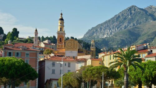 Video - Menton, France - September 4, 2024: Distant view of the St Michel Basilica surrounded by colourful buildings
