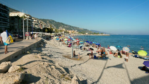 Video - Menton, France - September 4, 2024: People swimming and relaxing on the beach