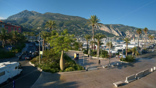 Video - Menton, France - September 4, 2024: Cars moving on the streets of the city near the harbour