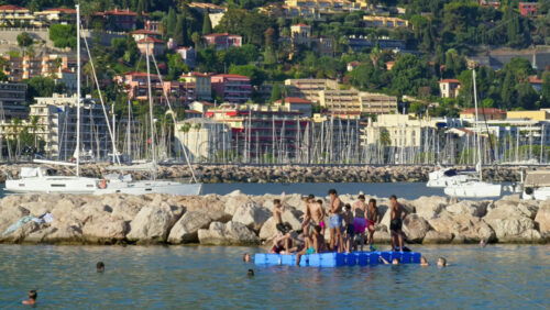 Video - Menton, France - September 4, 2024: People swimming and relaxing on the beach