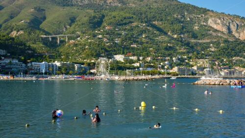 Video - Menton, France - September 4, 2024: People swimming and relaxing on the beach