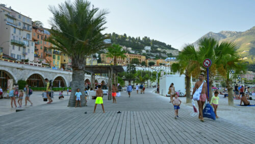 Video - Menton, France - September 4, 2024: People walking on the coastline in the evening