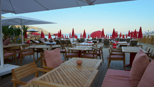 Video - Close up of tables at a restaurant on the beach in the evening
