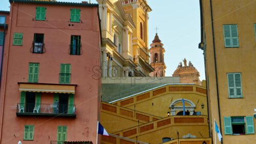 Video - Menton, France - September 4, 2024: View of the St Michel Basilica surrounded by colourful buildings