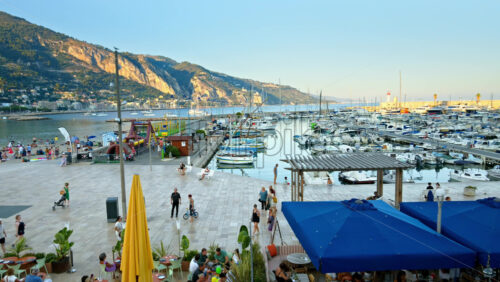 Video - View of the Port de Menton in the French Riviera with people walking near it